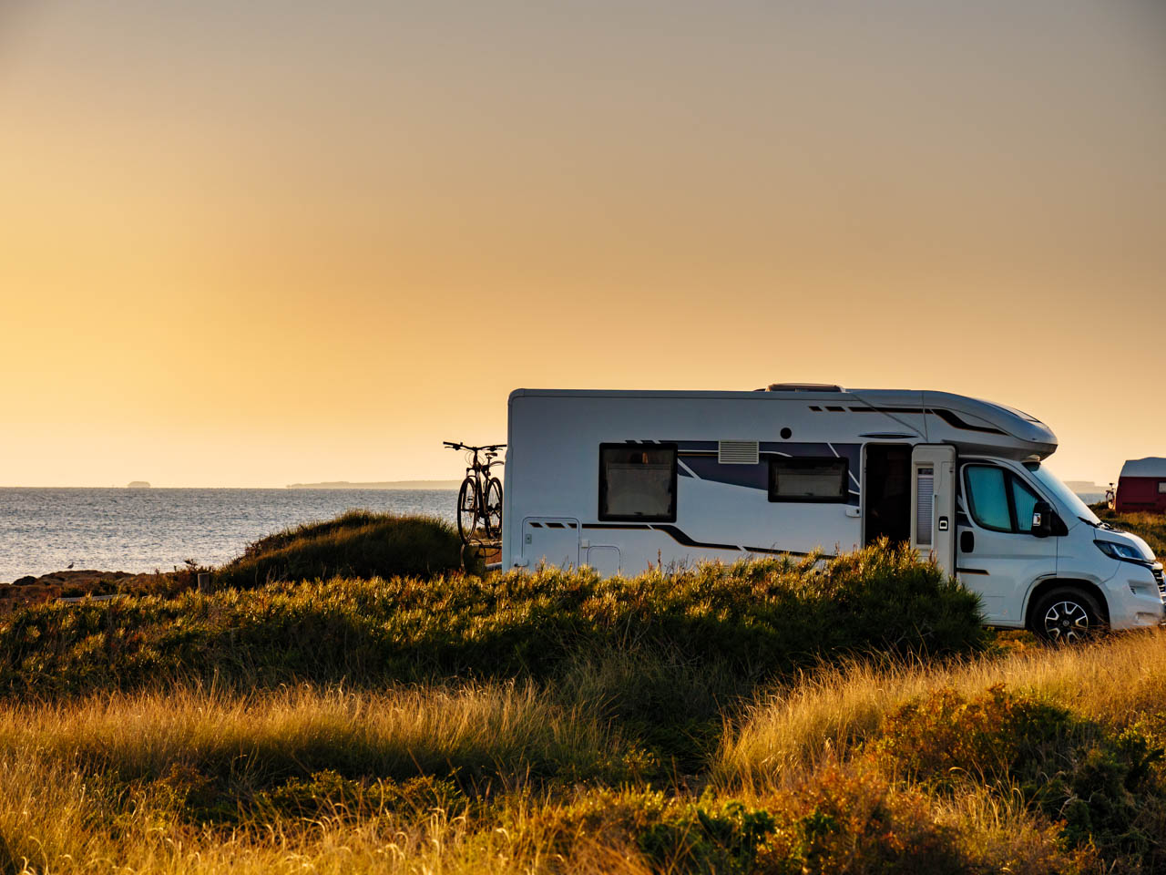 Camper with bicycle camp on beach